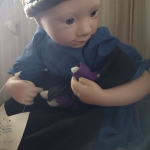 Porcelain Amish doll holding a little baby doll